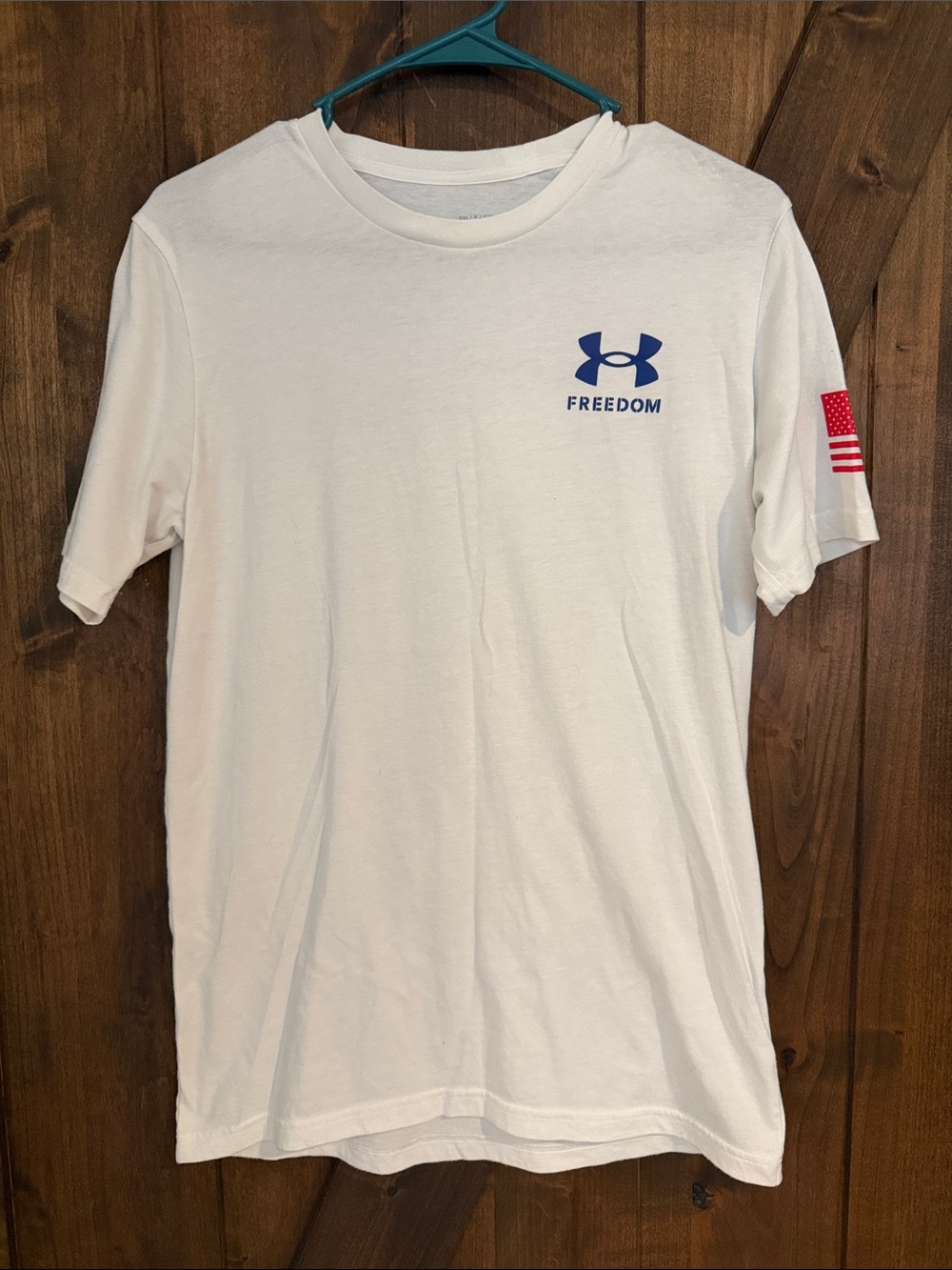 Under Armour White Short Sleeve Tee with Blue Logo and Red Flag Accent